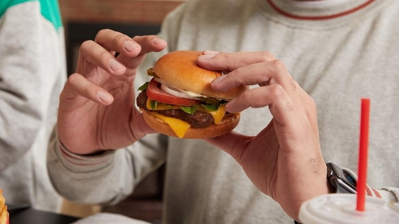 person eating a cheeseburger
