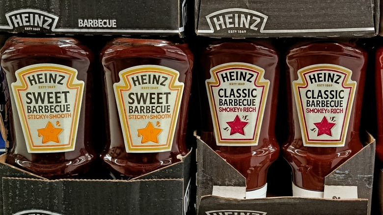 Heinz sauces in a supermarket, featuring barbecue varieties, tomato ketchup flavors, and mayonnaise on retail shelves.