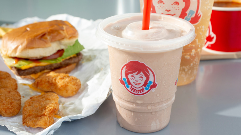 A Wendy's shake sits next to a burger and nuggets.
