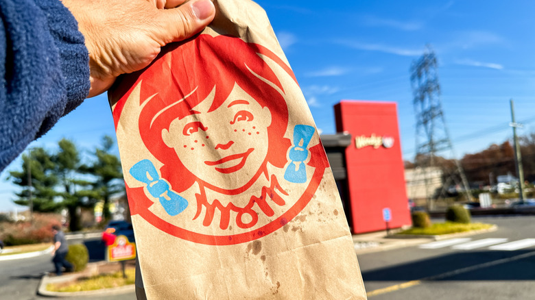 A paper Wendy's bag held up