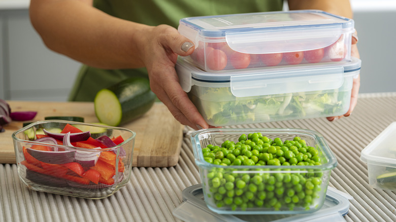 Person holding food storage containers