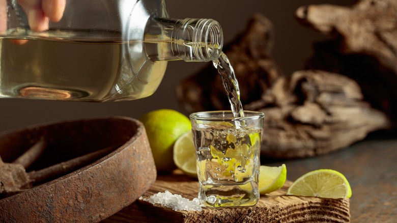 Pouring a shot of tequila.