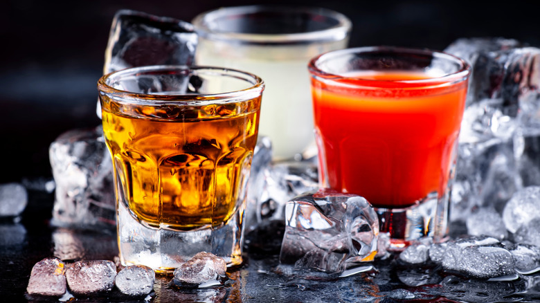 A golden tequila shot and a glass of sangrita.