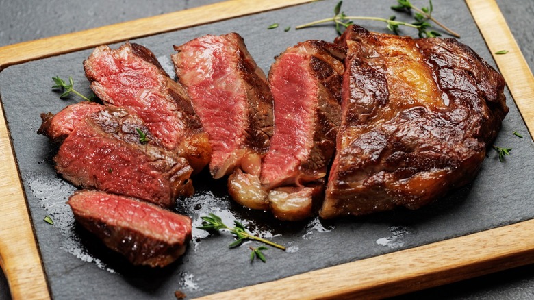 Sliced steak resting on cutting board