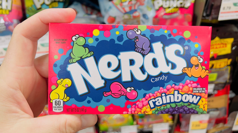 A hand holding a Nerds box