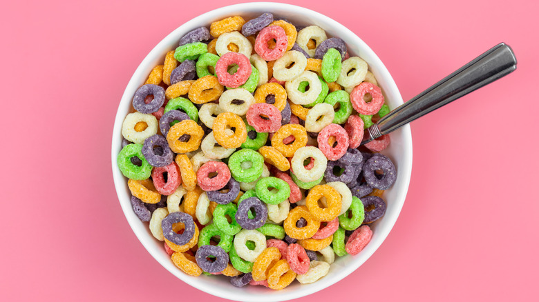 Bowl of Froot Loops cereal on a pink background