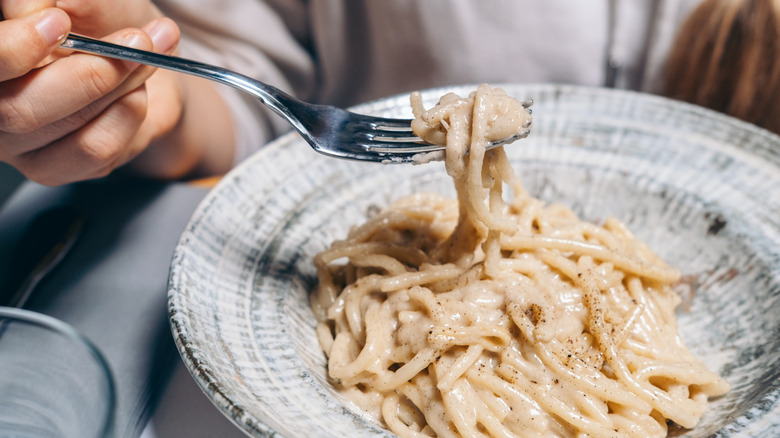 close-up of someone eating caccio peppe