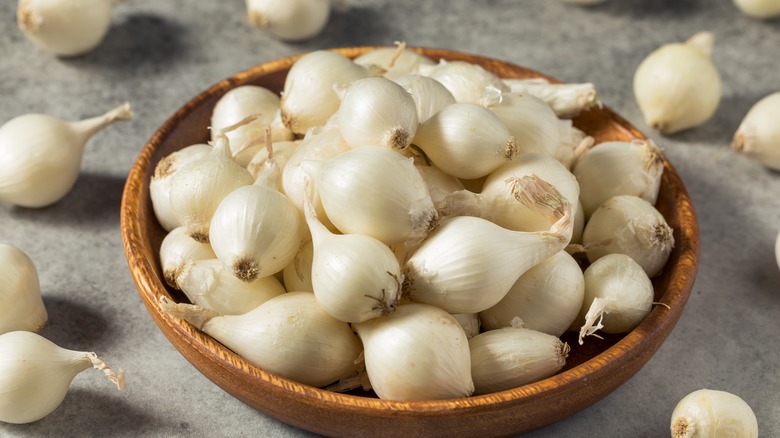 A bowl of white pearl onions on gray background