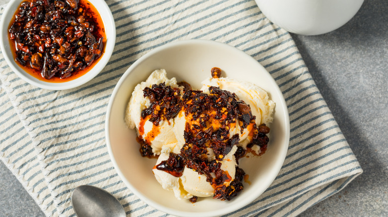 A bowl of vanilla ice cream topped with chili crisp