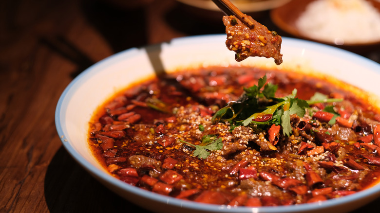 A bowl of Sichuan style beef with herbs and spices