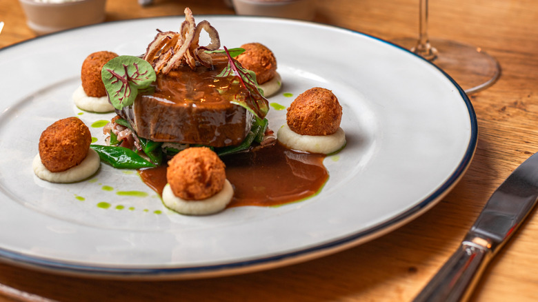 Venison steak served with sweetbreads