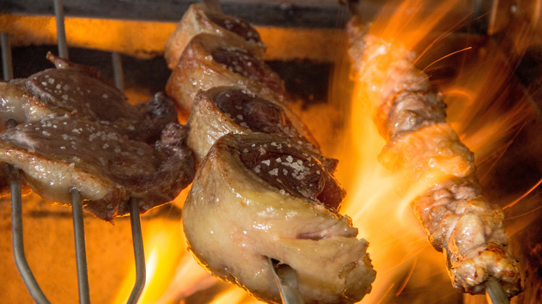 Skewer of grilled sweetbreads with other meats