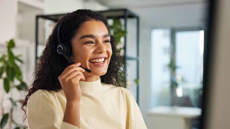 Woman smiling while wearing headset