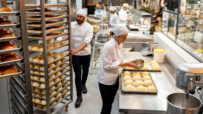 Workers bake bread at a bakery
