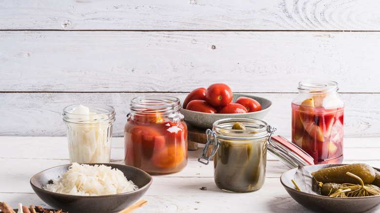Jars filled with different vegetables with some room on top