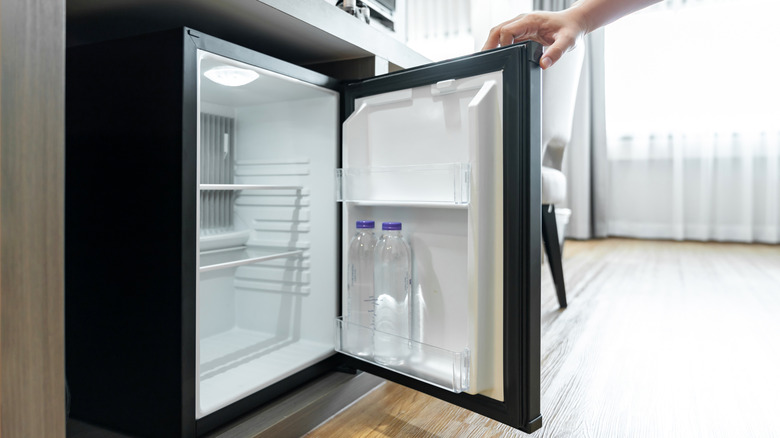Mini fridge being opened