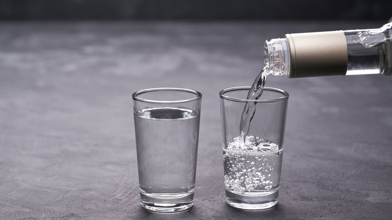 Pouring vodka into shot glasses