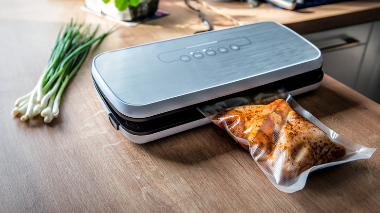 Vacuum sealing a bag of marinated meat