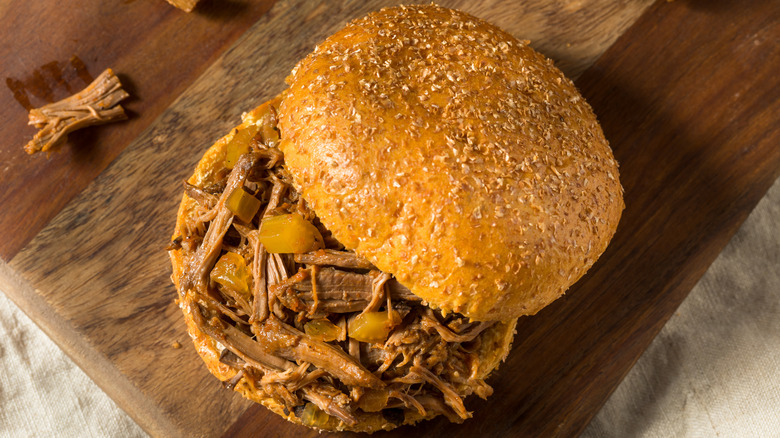 A pot roast sandwich with toasted burger buns and shredded pot roast