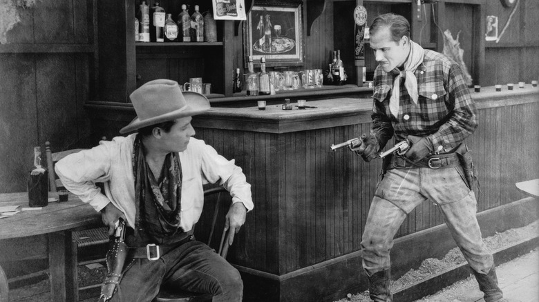 Old West saloon with bottles of drink on tables