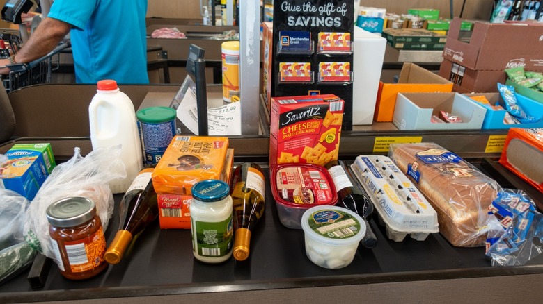 Groceries lined up on a checkout conveyor belt at an Aldi store.
