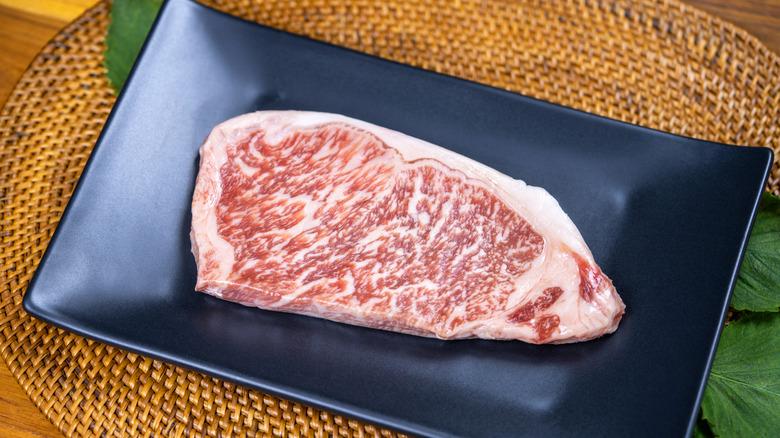 A plate containing a raw A5 Wagyu steak