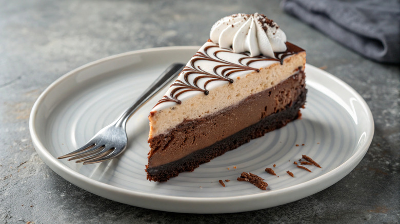 Slice of chocolate cheesecake with whipped cream from Cheesecake Factory