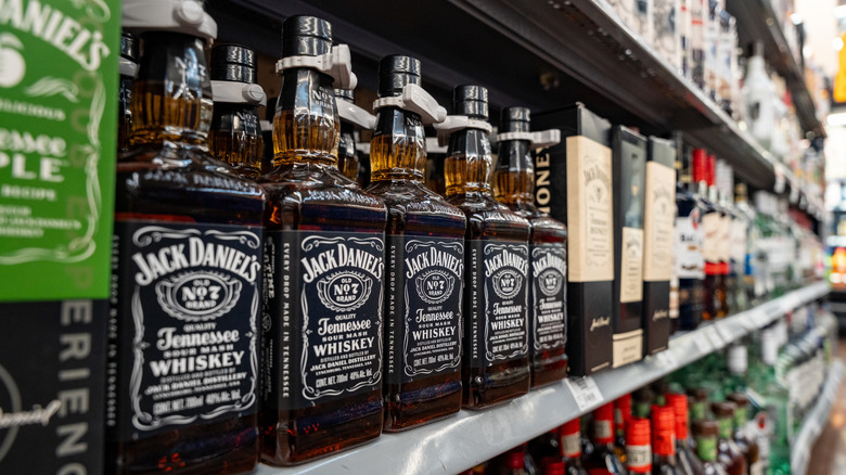 Bottles of Jack Daniel's No 7 lined up on a supermarket shelf.