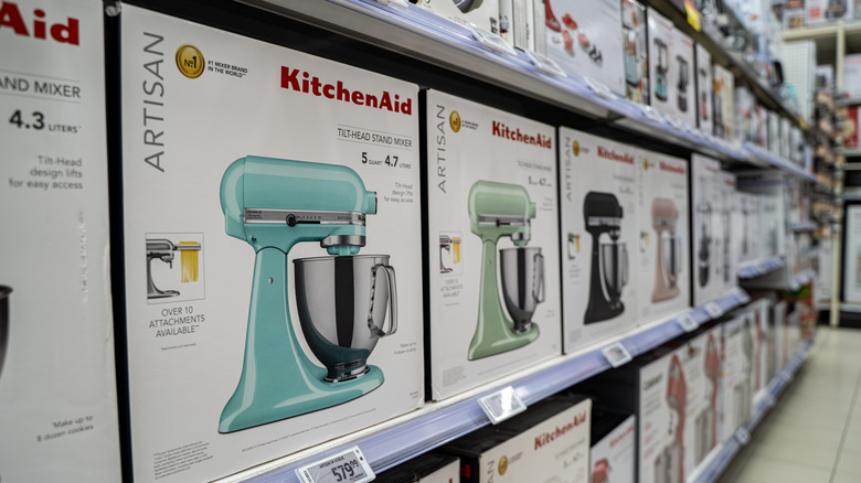 KitchenAid stand mixers in boxes on a store shelf