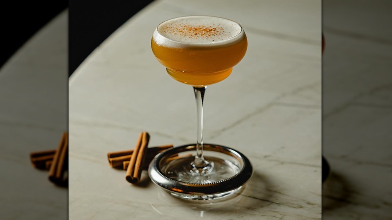 The Bow and Arrow cocktail in a glass with two cinnamon sticks at Nocturno cocktail lounge