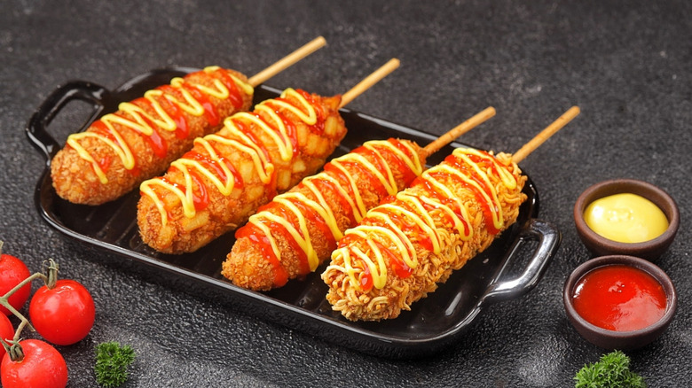 Corn dogs with ketchup, mustard