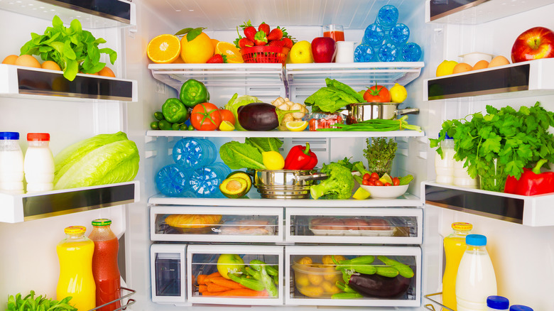 An open refrigerator filled with produce.