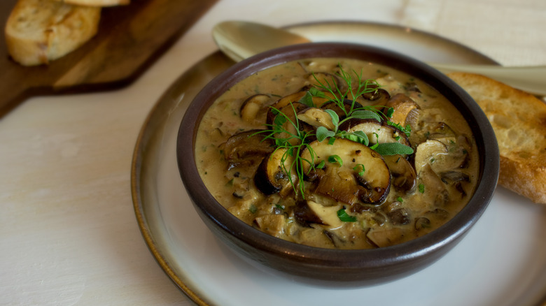 Creamy mushroom bisque in a ceramic brown bowl
