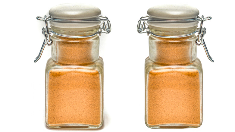 Two small spice jars filled with mushroom powder