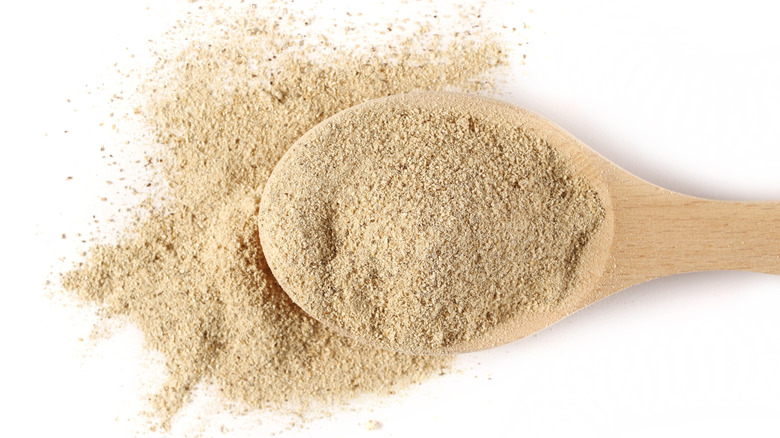 Shiitake mushroom powder in a wooden spoon