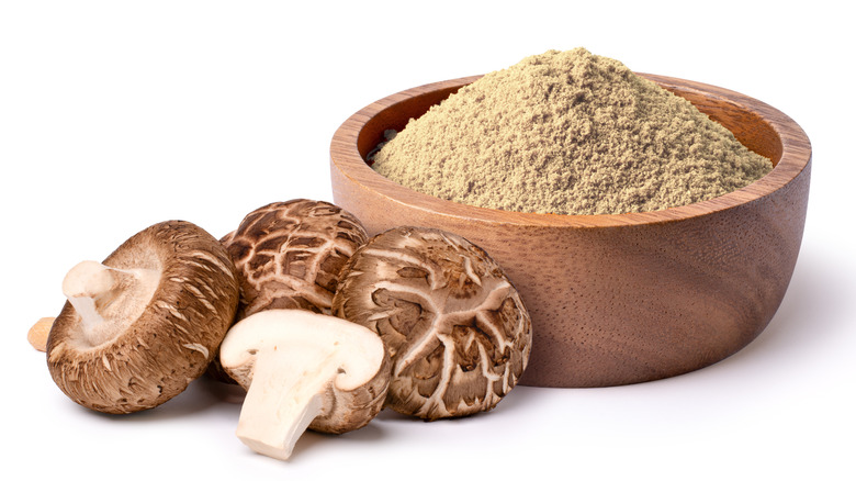 Shiitake mushrooms and mushroom powder in wooden bowl