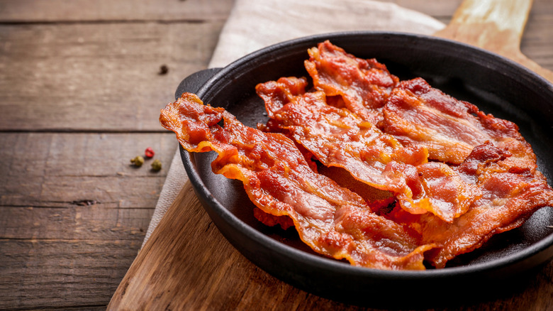 a cast iron pan with fried bacon