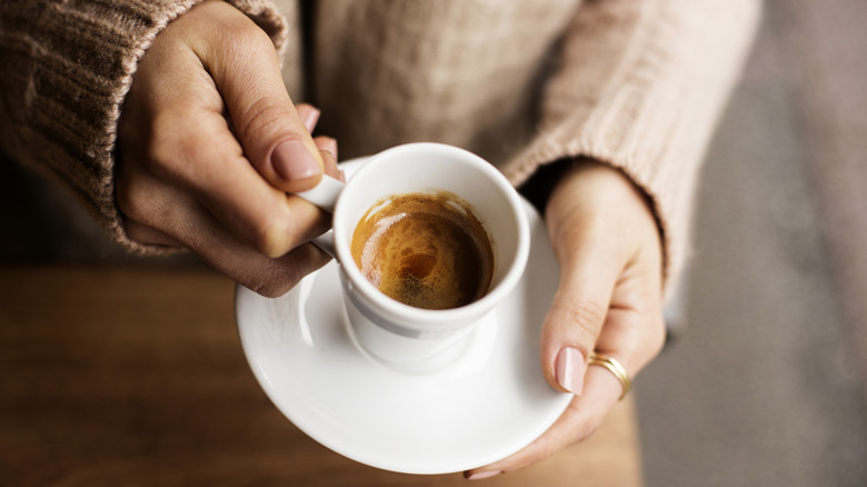Person holding an espresso
