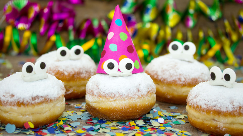 Individual pastries with funny eyes and party hats