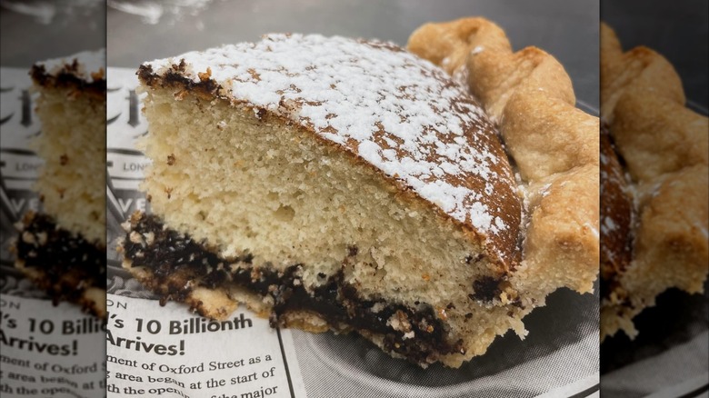 A slice of funny cake pie with the dessert's layers visible from the side