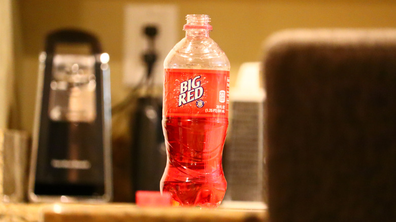 Single open bottle of Big Red soda