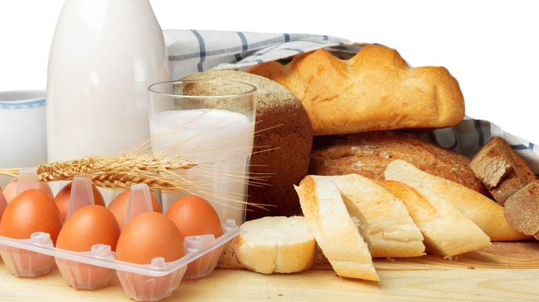 Milk, eggs, and bread on a white background.