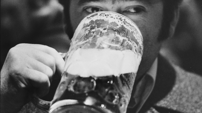 A man drinking stein of beer
