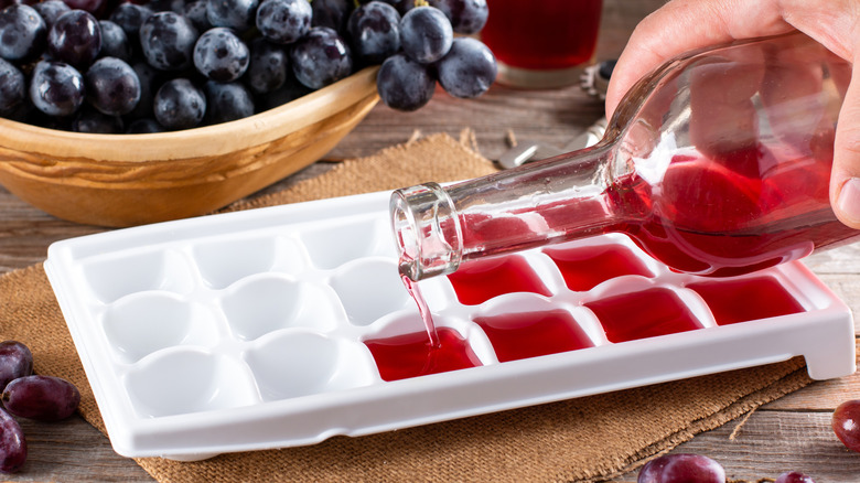pouring red wine in an ice cube tray