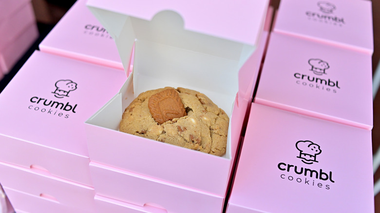 Crumbl cookie boxes with one open box.