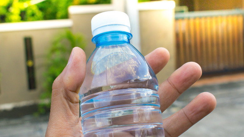 Person using plastic water bottle