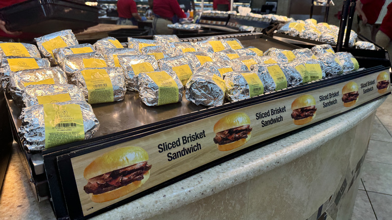 Wrapped brisket sandwiches on a heat plate at a Buc-ee's location.