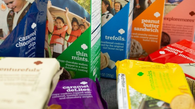 Colorful packages of Girl Scout cookies piled up together.