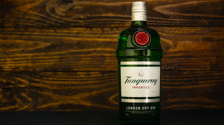 a bottle of Tanqueray gin on a wooden table