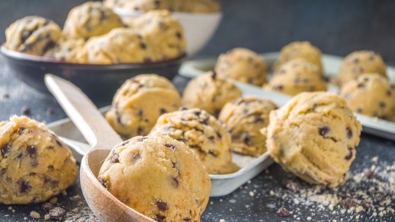 scoops of raw cookie dough on a baking sheet